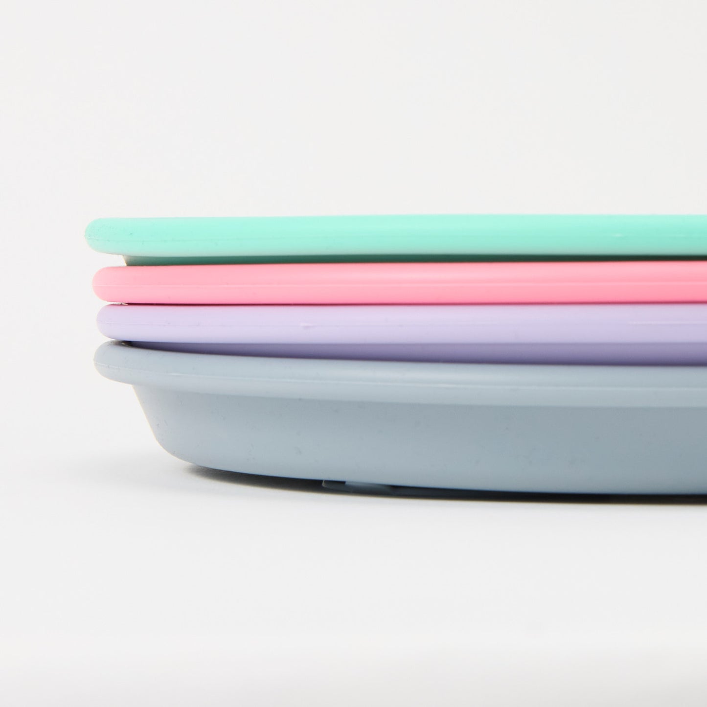 Three-section stainless steel toddler plate with pink, turquoise slate grey lilac silicone suction sleeve, food-grade, non-slip close up 
