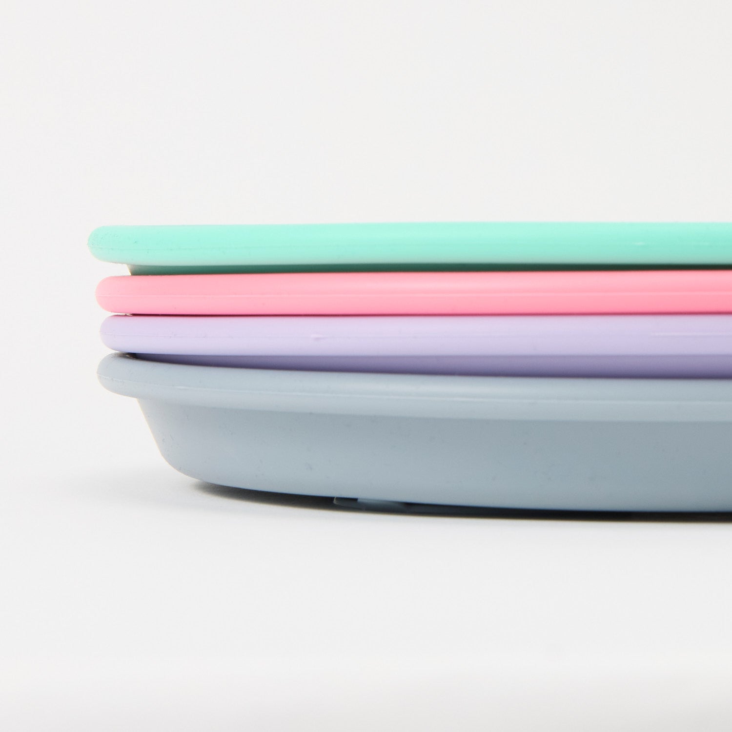 Three-section stainless steel toddler plate with pink, turquoise slate grey lilac silicone suction sleeve, food-grade, non-slip close up 