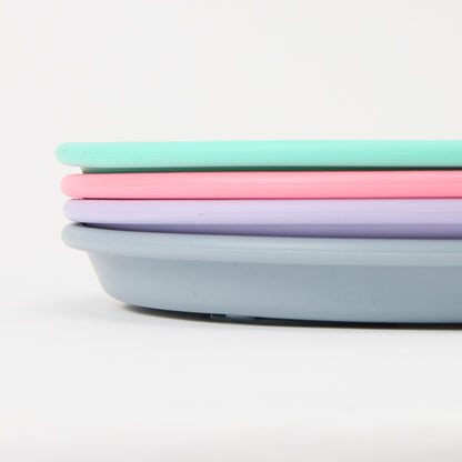Three-section stainless steel toddler plate with pink, turquoise slate grey lilac silicone suction sleeve, food-grade, non-slip close up 